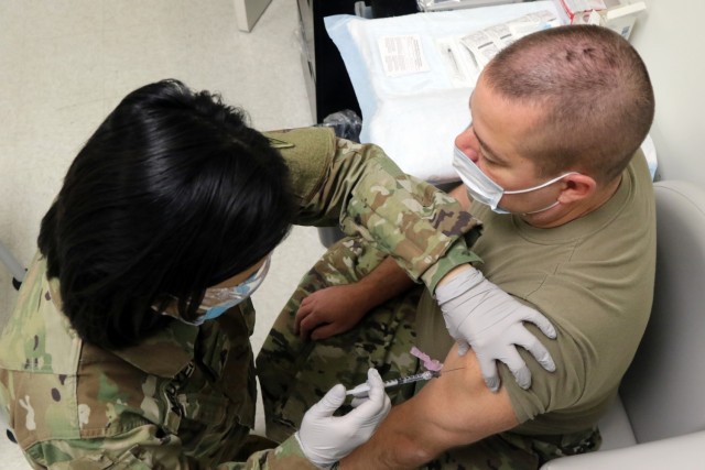 Sgt. Yen Nguyen, a combat medic with the Ohio Army National Guard Medical Detachment, administers the Moderna COVID-19 vaccine Dec. 22, 2020, at the Defense Supply Center Columbus. The Department of Defense is allocating the vaccine to the Ohio...