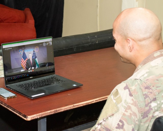 New York Police Officer and U.S. Army Staff Sgt. Samuel Garcia, intelligence analyst noncommissioned officer, 719th Movement Control Battalion, receives a special holiday call from New York City Police Commissioner Dermot Shea at Camp Arifjan, Kuwait, Dec. 23, 2020. During the call Shea thanked Garcia for his continued service to the nation as he serves his country in support of Operation Spartan Shield. (U.S. Army photo by Sgt. 1st Class Carlos Davis, 101st Division Sustainment Brigade Public Affairs)