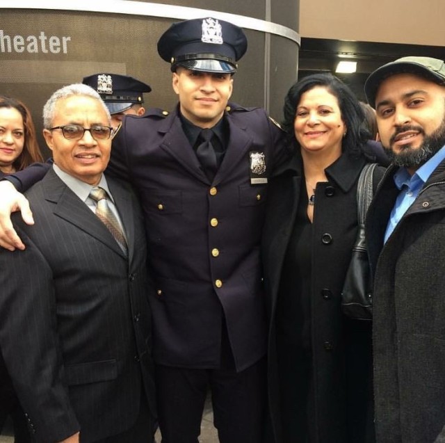 Staff Sgt. Samuel Garcia, intelligence analyst noncommissioned officer, 719th Movement Control Battalion, poses for a photo with his father and mother Adalberto and Maria Garcia, along with his brother Ronny Garcia at his New York City Police...
