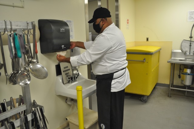 Martin Army Community Hospital Head Chef Francisco Elias washes his hands before cooking.