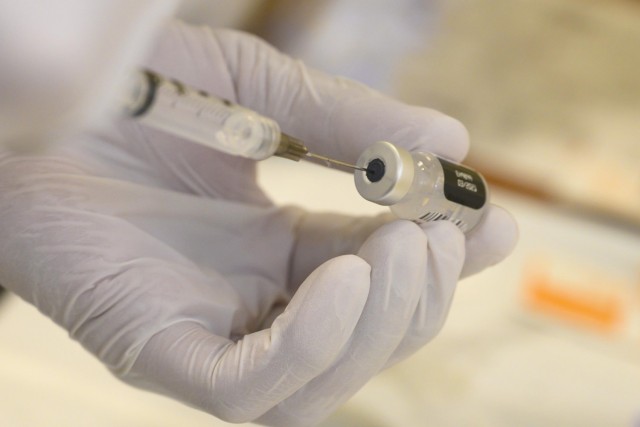 Navy Seaman Milan Torres prepares a dose of the COVID-19 vaccine to be administered to a patient at Walter Reed National Military Medical Center in Bethesda, Md., Dec. 14, 2020.