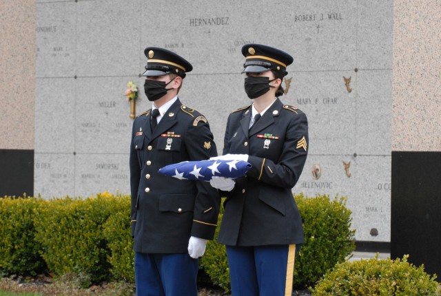 Spc. Austin Dycha and Sgt. Nikole Clark, members of the New York National Guard Military Funeral Honors Team, await the arrival of U.S. Army Air Force Cpl. Raymond Kegler at his funeral in Lackawanna, New York, May 14. Dycha and Clark wore cloth face masks as part of precautions being used during military funerals to prevent the spread of COVID-19. (Army National Guard Photo by Capt. Avery Schneider)