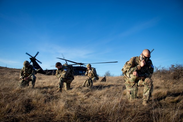U.S. Soldiers assigned to Kosovo Force, Regional Command-East, conduct a helicopter landing site clearance operation at Camp Bondsteel in Kosovo on Dec. 23, 2020. Soldiers with the 3rd Battalion, 238th General Support Aviation Battalion, Delaware...