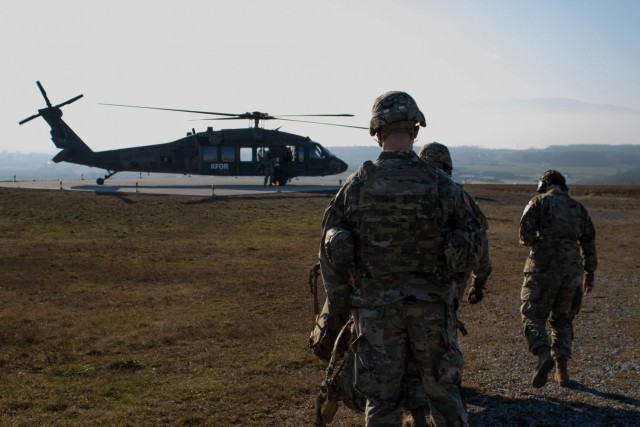 U.S. Soldiers assigned to Kosovo Force, Regional Command-East, prepare for a helicopter landing site clearance operation at Camp Bondsteel, Kosovo, on Dec. 23, 2020. Soldiers with the 3rd Battalion, 238th General Support Aviation Battalion,...