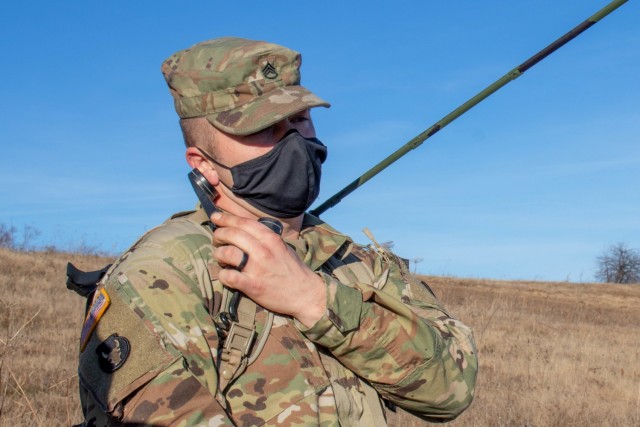 Staff Sgt. John Taft, a pathfinder assigned to Kosovo Force, Regional Command-East, maintains communications with aircraft pilots during a helicopter landing site clearance operation in Kosovo on Dec. 23, 2020. The ground team kept in contact with...
