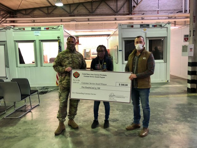 WIESBADEN, Germany – Annette Kamunya, postal operations assistant, receives her customer service award Dec. 18, 2020 at her U.S. Army Garrison Wiesbaden workplace. Photo by Brittany Casey.