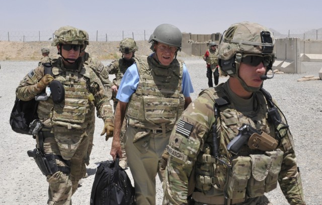 Lou Holtz (center) prepares to board a helicopter while traveling with Operation Honor Our Troops at Forward Operating Base Spin Boldak, Kandahar province, Afghanistan, June 6, 2013.