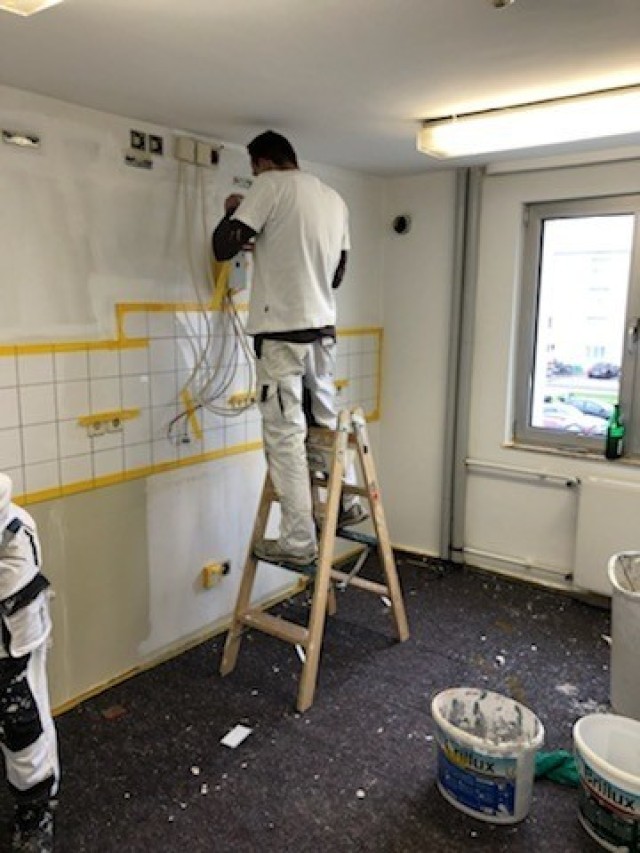 WIESBADEN, Germany - A U.S. Army Garrison Wiesbaden Directorate of Public Works employee paints a kitchen in the barracks on Clay Kaserne as part of a plan to upgrade Soldier quarters and improve quality of life.