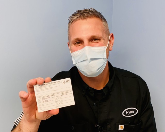 Registered nurse, Mr. Ryan Diehl, a frontline healthcare worker assigned to Blanchfield Army Community Hospital’s Emergency Center, shows his COVID-19 Vaccination Record Card before adding his personal information. He and other healthcare workers and first responders are among the first recipients of the first phase of COVID vaccines on Fort Campbell. Under the CDC guidelines, military and civilian healthcare workers and first responders directly involved in the hospital’s COVID response who have a high risk of exposure to the virus while carrying out their duties will be vaccinated first, keeping them in the fight. Ultimately, a multi-phased plan will make the vaccine available to any service member, retiree and family member, Department of Defense civilian and contractors who volunteer to receive it. U.S. Army photo by Maria Yager.