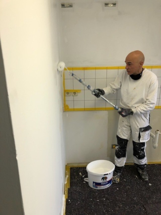 WIESBADEN, Germany - A U.S. Army Garrison Wiesbaden Directorate of Public Works employee paints a kitchen in the barracks on Clay Kaserne as part of a plan to upgrade Soldier quarters and improve quality of life.