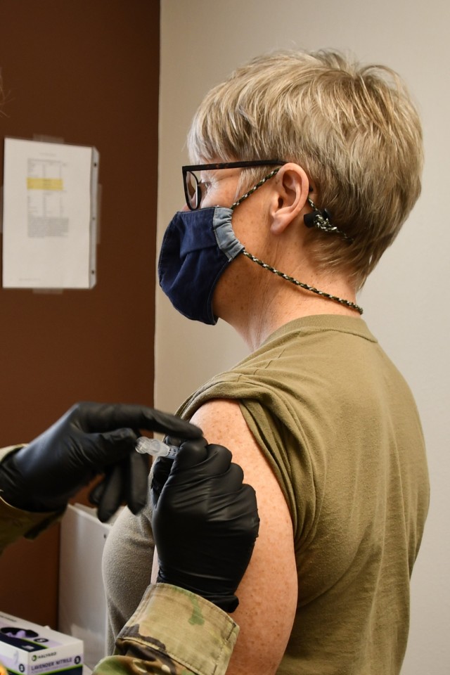 Chief Warrant Officer 5 Julie Vaquera, the Montana National Guard state command warrant officer, receives her first dose of the Moderna COVID -19 vaccine from Capt. Kaleigh Koeppen at the Fort Harrison Medical Detachment Jan. 5, 2021.