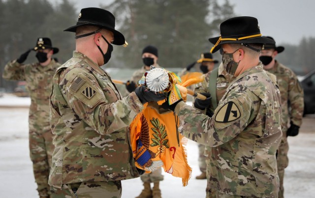 2nd Battalion, 8th Cavalry Regiment, 1st Armored Brigade Combat Team, 1st Cavalry Division Commander Lt. Col. Steven E. Jackowski and Command Sgt. Maj. Jesus Pena carefully unfurl the battalion’s colors Jan. 4, 2021. The small, socially...
