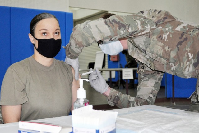 Col. Tanya Peacock, commander of U.S. Army Medical Department Activity ̶ Japan, receives a COVID-19 vaccine shot at the Community Recreation Center, Camp Zama, Japan, Jan. 6. Pfc. Nathan Salsgiver, a medic assigned to MEDDAC ̶ J, administers the...