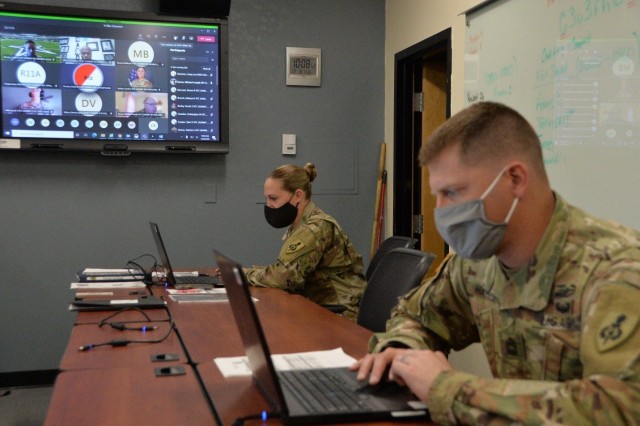 Master Sgts. Dolly Mast and Keith Harris, facilitators of the Master Leader Course at the NCO Leadership Center of Excellence, wear masks and maintain social distance during a MLC block of instruction, Dec. 8. Although the MLC Resident Course facilitators had to adapt to a virtual learning environment as a result of coronavirus safety precautions, over 1300 Soldiers in the rank of sergeants first class have completed the course with the NCOLCoE since the onset of the pandemic. 