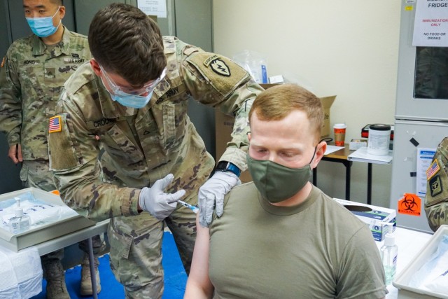 Capt. Eric Roggow, senior medical officer for the 4th Infantry Brigade Combat Team (Airborne), 25th Infantry Division, “Spartan Brigade,” receives his initial dose of the Pfizer COVID-19 vaccine Jan. 6, 2021, Joint Base Elmendorf-Richardson. The first troops in the Spartan Brigade to receive the vaccine were medics, physicians, key leaders and other designated volunteers that would likely deploy first in an emergency.