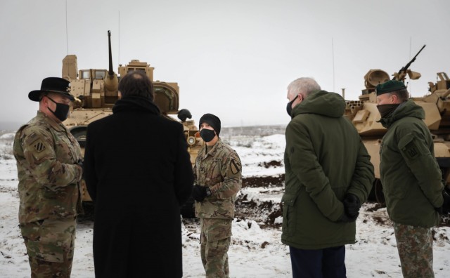 Commander of 2nd Battalion, 8th Cavalry Regiment, 1st Armored Brigade Combat Team, 1st Cavalry Division, left, speaks with U.S. Ambassador to Lithuania Robert Gilchrist, center, Lithuanian Minister of Defense Arvydas Anusaukas, right, and...