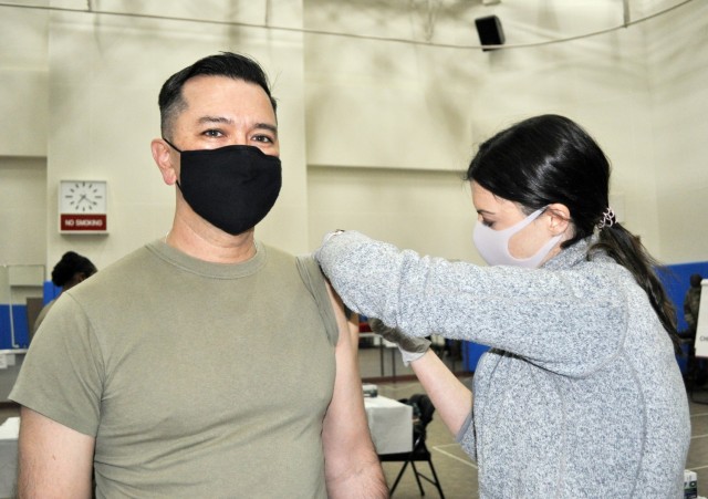 Col. Thomas Matelski, left, commander of U.S. Army Garrison Japan, receives a COVID-19 vaccine shot at the Community Recreation Center, Camp Zama, Japan, Jan. 6. Amanda Winters, a community health nurse assigned to preventive medicine, U.S. Army...