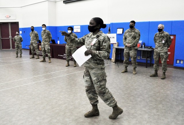 Capt. Amber Morton-Chism, assigned to U.S. Army Medical Department Activity ̶ Japan, briefs medical personnel before they start administering COVID-19 vaccine shots at the Community Recreation Center, Camp Zama, Japan, Jan. 6.