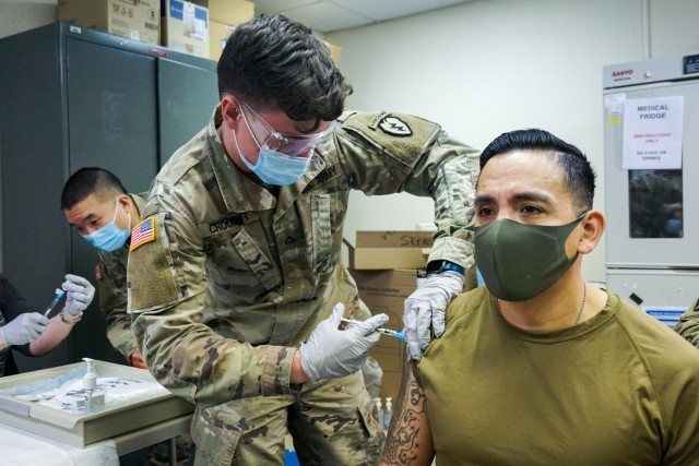 Command Sgt. Maj. Alex Kupratty, command sergeant major of the 4th Infantry Brigade Combat Team (Airborne), 25th Infantry Division, “Spartan Brigade,” receives his initial dose of the Pfizer COVID-19 vaccine Jan. 6, 2021, Joint Base Elmendorf-Richardson. The first troops in the Spartan Brigade to receive the vaccine were medics, physicians, key leaders and other designated volunteers that would likely deploy first in an emergency.