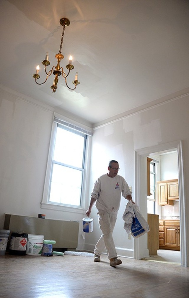 Scott Little, painter with Fort Leavenworth Frontier Heritage Communities, moves painting supplies in a recently patched and painted room March 26, 2020, in Infantry Barracks. Infantry Barracks quarters underwent renovations, to include updated light fixtures, new bathroom vanities and new kitchen countertops. Photo by Prudence Siebert/Fort Leavenworth Lamp