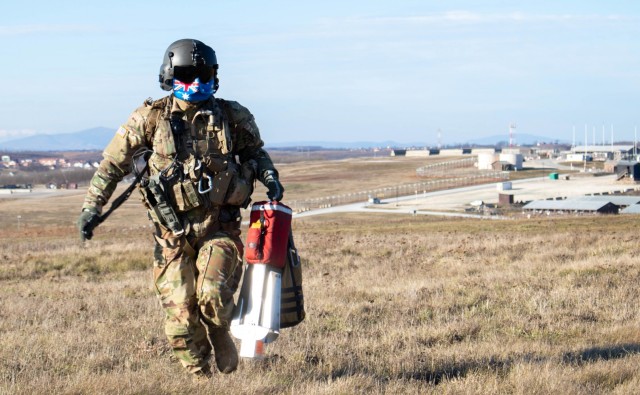 Sgt. Abraham Boxx, a critical care flight paramedic with the 1st Battalion, 168th General Support Aviation Battalion, Washington Army National Guard, carries hoist systems used during dynamic hoist training at Camp Bondsteel Kosovo on Jan. 2,...