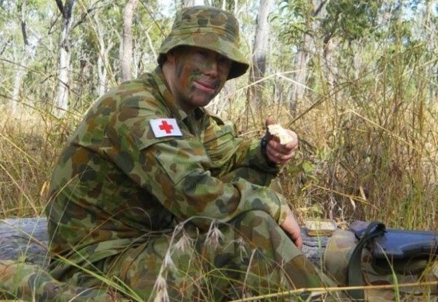 Sgt. Abraham Boxx, a critical care flight paramedic with the 1st Battalion, 168th General Support Aviation Battalion, Washington Army National Guard, eats a ration pack during exercise Talisman Sabre at Rockhampton, Queensland, in 2008. Boxx served in the Australian Army from 2007 to 2016 and deployed three times as a combat medic before joining the Washington Army National Guard.