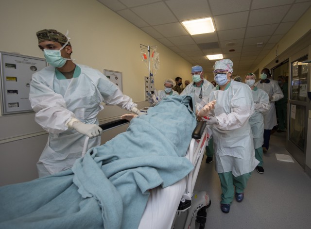 Members of the 555th Forward Surgical Team rush a simulated trauma patient to surgery during training with the Strategic Trauma Readiness Center of San Antonio (STaRC) at Brooke Army Medical Center, Fort Sam Houston, Texas, May 28, 2020. The STaRC training program leverages the expertise and capabilities across multiple healthcare disciplines at BAMC, the U.S. Army Institute of Surgical Research, the Medical Center of Excellence, the Joint Trauma System and the Air Force 59th Medical Wing to provide deploying surgical teams with the most realistic and comprehensive wartime skills certification.  (U.S. Army photo by Jason W. Edwards)