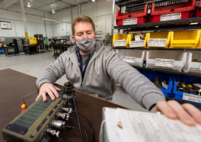 Frederick Orlando, electronics worker, tests the power module for the Wireless Independent Target System.