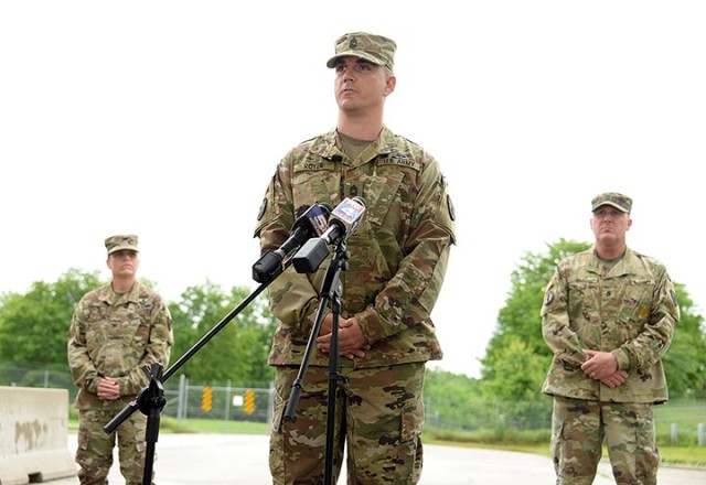 Master Sgt. David Royer, 705th Military Police Battalion (Detention), supported by 15th MP Brigade Commander Col. Caroline Smith and 705th MP Battalion Command Sgt. Maj. Justin Shad, speaks to area reporters about taking action to subdue an active shooter the day before on Centennial Bridge in Leavenworth during a press conference May 28, 2020, at Sherman Gate. Photo by Prudence Siebert/Fort Leavenworth Lamp