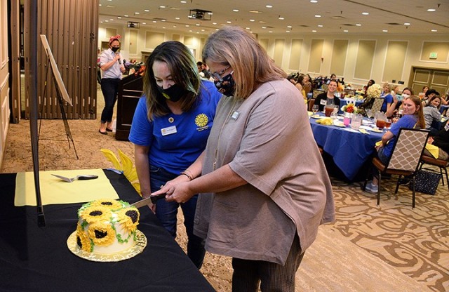 Fort Leavenworth Spouses’ Club President Heather Alvarado and FLSC Honorary President Tracy Rainey cut a cake to recognize the 100th anniversary of the club during the FLSC 100th birthday celebration luncheon Oct. 14, 2020, at the Frontier Conference Center. Photo by Prudence Siebert/Fort Leavenworth Lamp