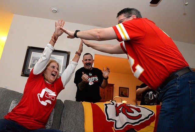 Retired Lt. Col. Bill Welch, center, operations research analyst at The Research and Analysis Center, applauds as Betty Welch and retired Lt. Col. Gary Linhart, Military History Instruction Support Team chief, high-five to celebrate a touchdown by the Kansas City Chiefs during a Super Bowl watch party Feb. 2, 2020, at Linhart’s home in Lansing. The Chiefs beat the San Francisco 49ers 31-20. Photo by Prudence Siebert/Fort Leavenworth Lamp
