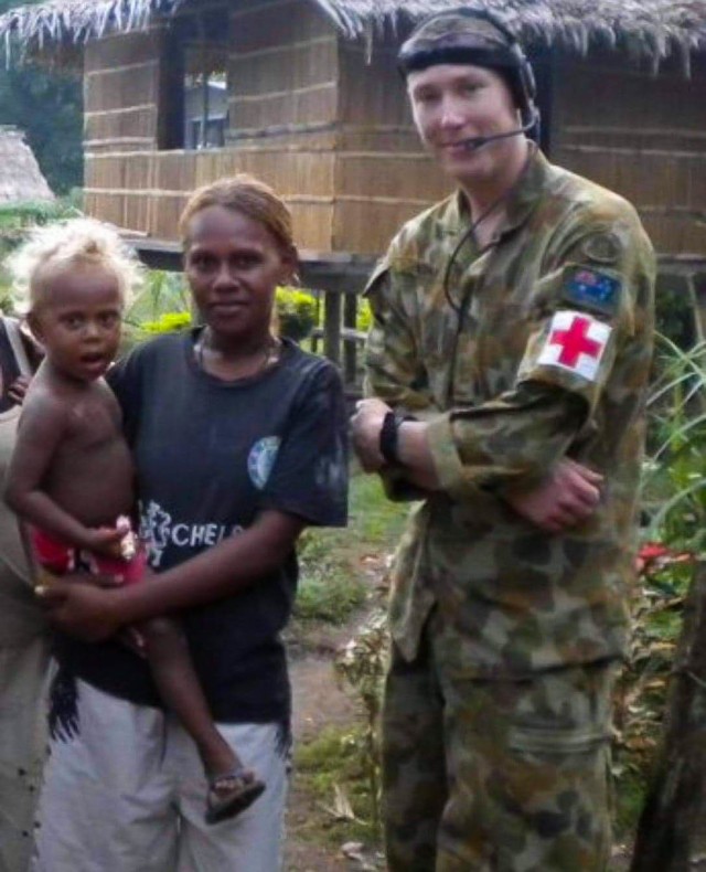 Sgt. Abraham Boxx, a critical care flight paramedic with the 1st Battalion, 168th General Support Aviation Battalion, Washington Army National Guard, poses for a photo with a local during a deployment to the Solomon Islands in 2010. Boxx served in the Australian Defense Force from 2007 to 2016 and deployed three times as a combat medic before joining the Washington Army National Guard.