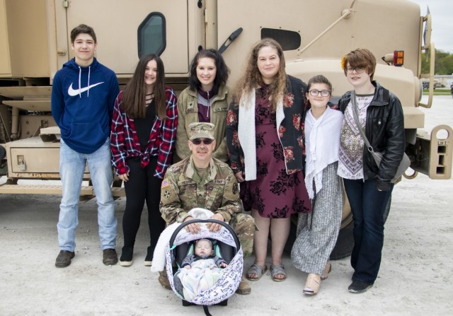 Sgt. Timothy Hesse Sr. poses with his family before a ceremony to award him the Iowa Medal of Merit at Camp Dodge Joint Maneuver Training Center on May 13, 2020. On Aug. 15, 2019, Hesse, a motor transport operator with the 113rd, administered CPR...