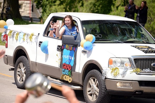 Patton Junior High School ninth-grader Anneliesse Murphy waves to spectators with her mother, Alisa, from a decorated truck driven by her dad, Chris, during the graduation parade May 15, 2020, on Scott Avenue. Photo by Prudence Siebert/Fort...