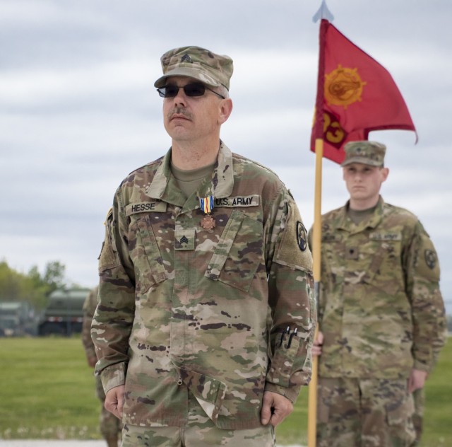 Sgt. Timothy Hesse Sr. stands at attention after Maj. Gen. Ben Corell, Adjutant General of the Iowa National Guard, pinned on the Iowa Medal of Merit at Camp Dodge Joint Maneuver Training Center on May 13, 2020. On Aug. 15, 2019, Hesse, a motor...