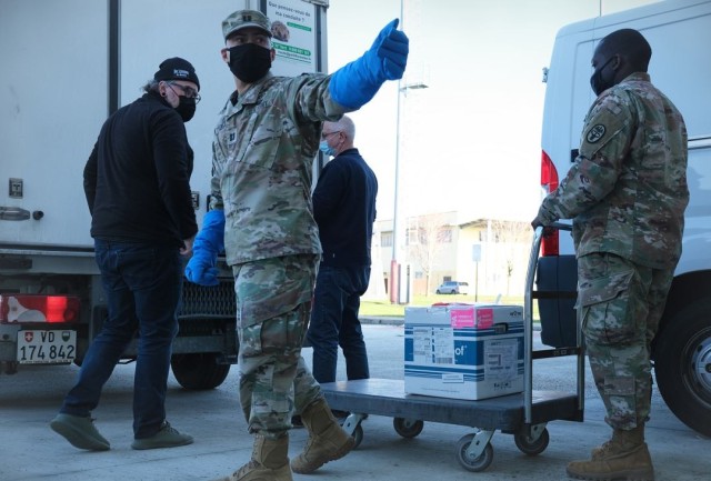 Capt. Jose Melendez acknowledges the arrival of USAG Italy's first COVID-19 vaccines from a temperature controlled vehicle January 7, 2021 in Vicenza, Italy.
