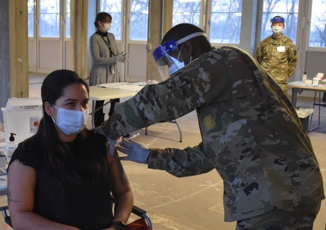 MONS, Belgium – Sgt. Kalinda Montañez, left, pharmacy noncommissioned officer in charge at SHAPE Healthcare Facility, receives a COVID-19 vaccination Jan. 8 at the SHAPE Healthcare Facility at Mons, Belgium, Jan. 8. The SHAPE Healthcare...