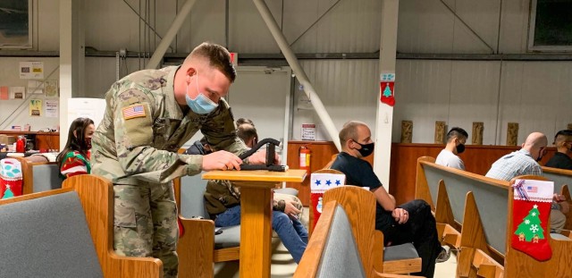 MIHAIL KOGALNICEANU, Romania – Spc. Joshua Smith, Area Support Group-Black Sea, Religious Affairs non-commissioned officer in charge, Alabama National Guard, sets up a camera for live streaming the Christmas Eve Service here. Spc. Smith uses his...