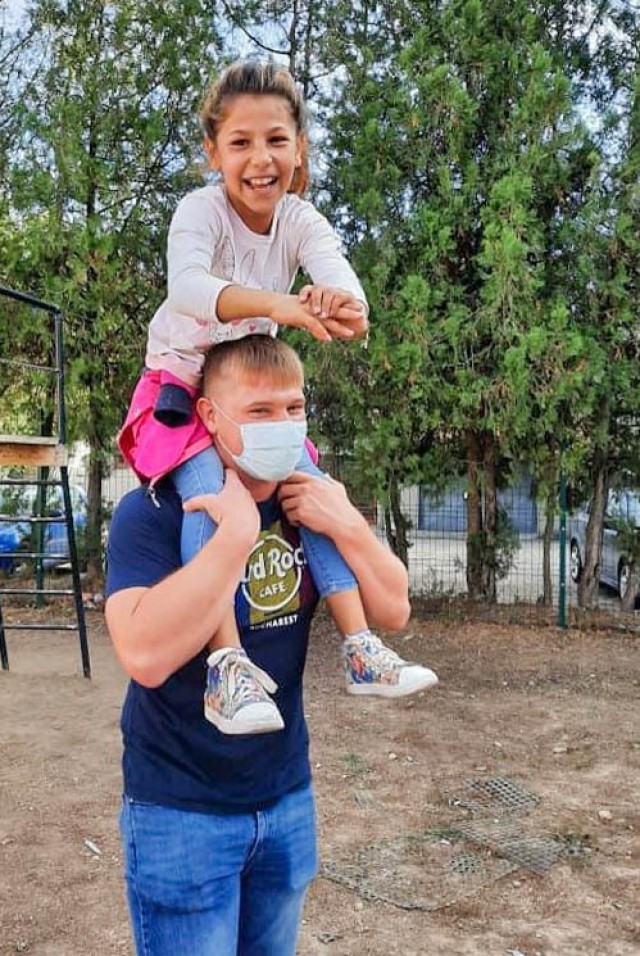 MEGIDIA, Romania. – Spc. Joshua Smith, Area Support Group-Black Sea, Religious Affairs non-commissioned officer in charge, Alabama National Guard, carries a child on his shoulders during a Soldier visit to Stepping Stone Missions. Spc. Smith...