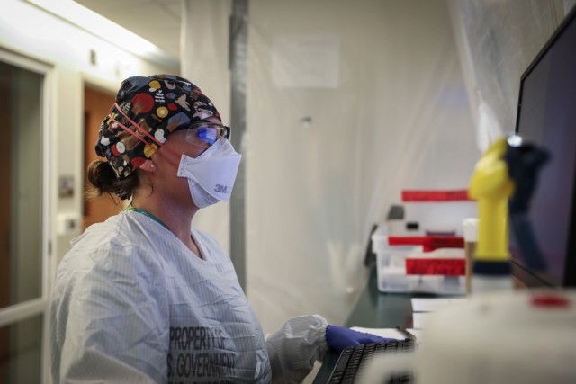 U.S. Navy Lt. Cmdr. Sarah Jagger, Rural Rapid Response Team Leader and a critical care nurse, reviews patient charts while working in the COVID-19 ward at the Northern Navajo Medical Center, Shiprock, N.M., Dec. 23, 2020. U.S. Northern Command,...