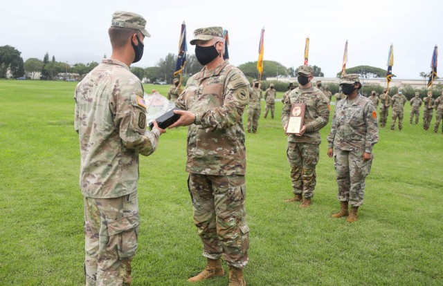 Capt. John Walsh, former commander of Echo Company, 3rd General Support Aviation Battalion, 25th Aviation Regiment, 25th Combat Aviation Brigade, 25th Infantry Division, accepts an award given by General Paul LaCamera, Commanding General of United States Army Pacific, on Schofield Barracks, Hawaii, Nov. 20, 2020. Echo Company received the award for winning the 2019 Army Achievement Award for Maintenance Excellence.