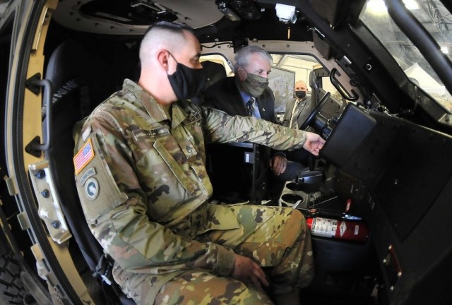 Staff Sgt. Derrick Felch, left, an Ordnance School instructor, explains Joint Light Tactical Vehicle controls to Undersecretary of the Army James McPherson during his visit to Fort Lee, Va., Oct. 7, 2020.