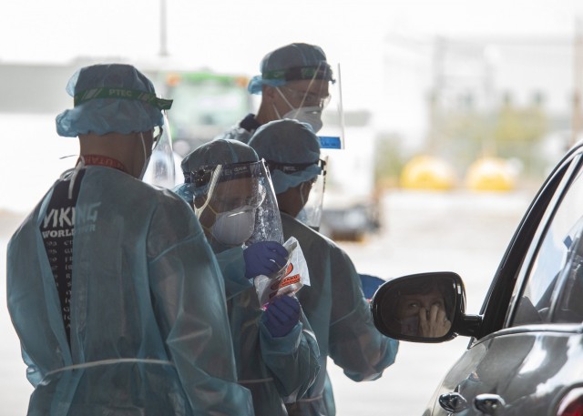 Members of the Utah Air and Army National Guard conduct tests for COVID-19 as part of a mobile testing team on Nov. 7, 2020, in Wendover, Utah. The Utah Air and Army National Guard was activated in early 2020 to assist in COVID-19 testing...