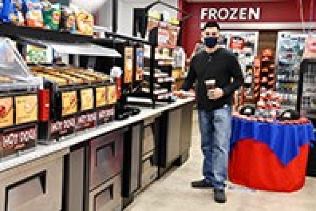 Chief Warrant Officer 2 Frank Rico, 3rd Brigade Combat Team, 10th Mountain Division, picked up a free slice of Hunt Brothers Pizza as part of the ribbon cutting celebration held at Express 3 Jan. 6.