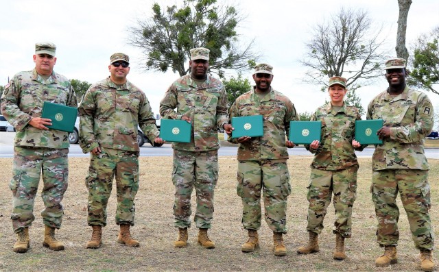 U.S. Army Reserve Soldiers part of the command staff for the 3-312th Training Support Battalion, Fort Meade, Maryland, share in a candid moment after an awards ceremony for recognition of their hard work and dedication during the mobilization process and achieving mission readiness December 18 at Fort Hood, Texas. The unit is on a yearlong assignment to Fort Hood in support of operations for First Army Division West, 120th Infantry Brigade. (U.S. Army Reserve Photo Staff Sgt. Erick Yates)