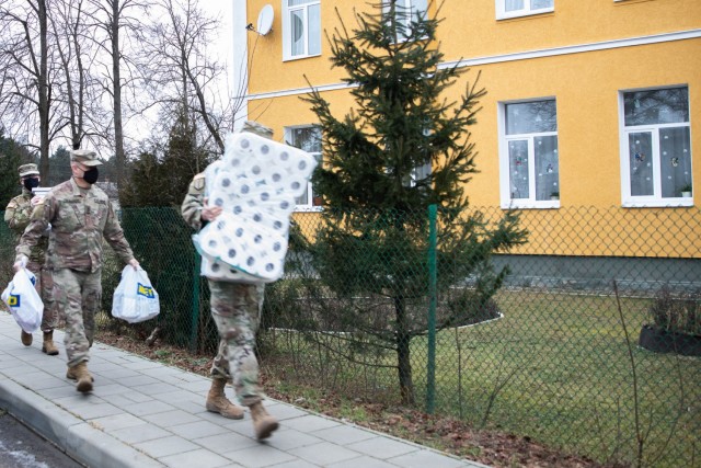 Task Force Illini Soldiers carry in donated supplies to the Krakovets Rehabilitation Center for Children with Disabilities in Krakovets, Ukraine, Jan. 11. (U.S. Army Photo, Cpl. Shaylin Quaid)