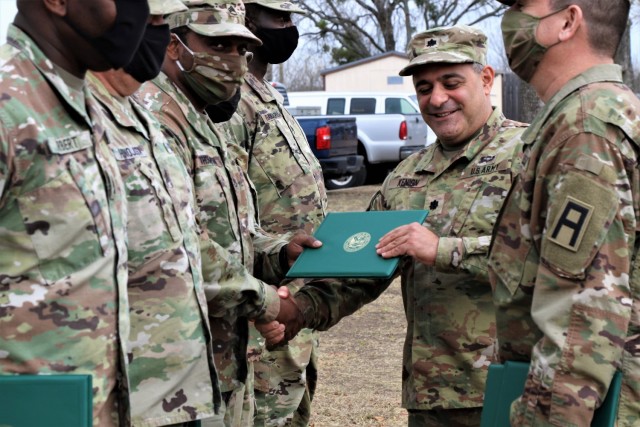 U.S. Army Lt. Col. Benjamin Kenion, commander 3-312th Training Support Battalion, Fort Meade, Maryland, and Command Sgt. Maj. Michael Lopez, senior enlisted advisor for the Battalion, congratulates Soldiers part of the battalion command staff...