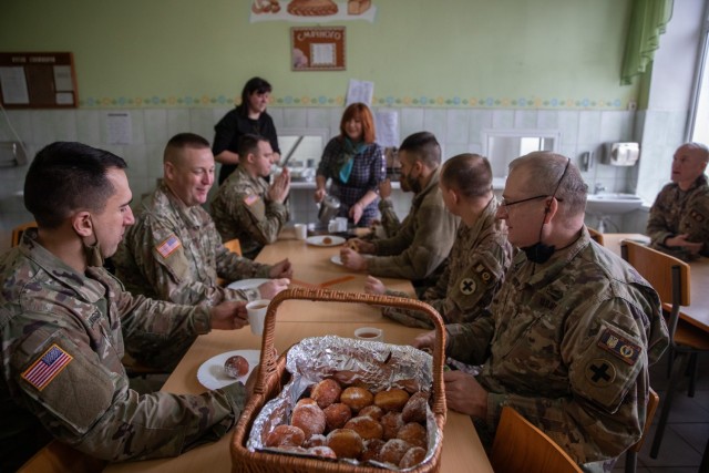 Task Force Illini Soldiers enjoy traditional Ukrainian donuts and tea provided by the Krakovets Rehabilitation Center for Children with Disabilities in Krakovets, Ukraine, Jan 11. (U.S. Army Photo, Cpl. Shaylin Quaid)