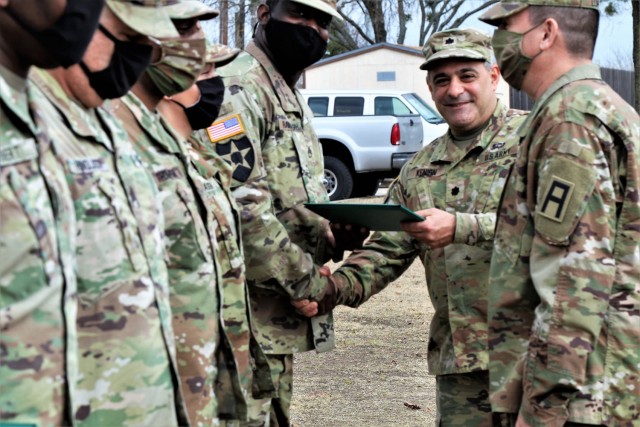 U.S. Army Lt. Col. Benjamin Kenion, commander 3-312th Training Support Battalion, Fort Meade, Maryland, and Command Sgt. Maj. Michael Lopez, senior enlisted advisor for the Battalion, congratulates Soldiers part of the battalion command staff...