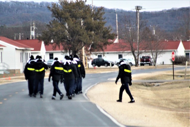 U.S. Navy recruits walk on the cantonment area Dec. 15, 2020, at Fort McCoy, Wis. The Navy’s Recruit Training Command (RTC) of Great Lakes, Ill., worked with the Army at Fort McCoy so the post could serve as a restriction-of-movement (ROM) site...